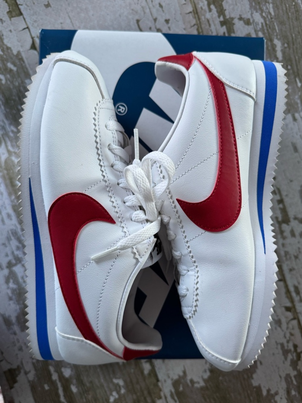 Nike Women's White Sneakers with Red Swoosh and Blue Sole Stripe